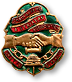 Märke för kedjearbetarnas fackförbund, i form av en sköld i grönt, rött och guld