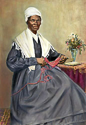 Kolorerat foto av Sojourner Truth sittande vid ett bord som det står en vas med blommor på
