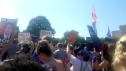 Foto av demonstranter i Washington mot tillsättningen av Kavanaugh till högsta domstolen hösten 2018. På ett plakat syns en bild av Kavanaugh med texten "Kavanoff"